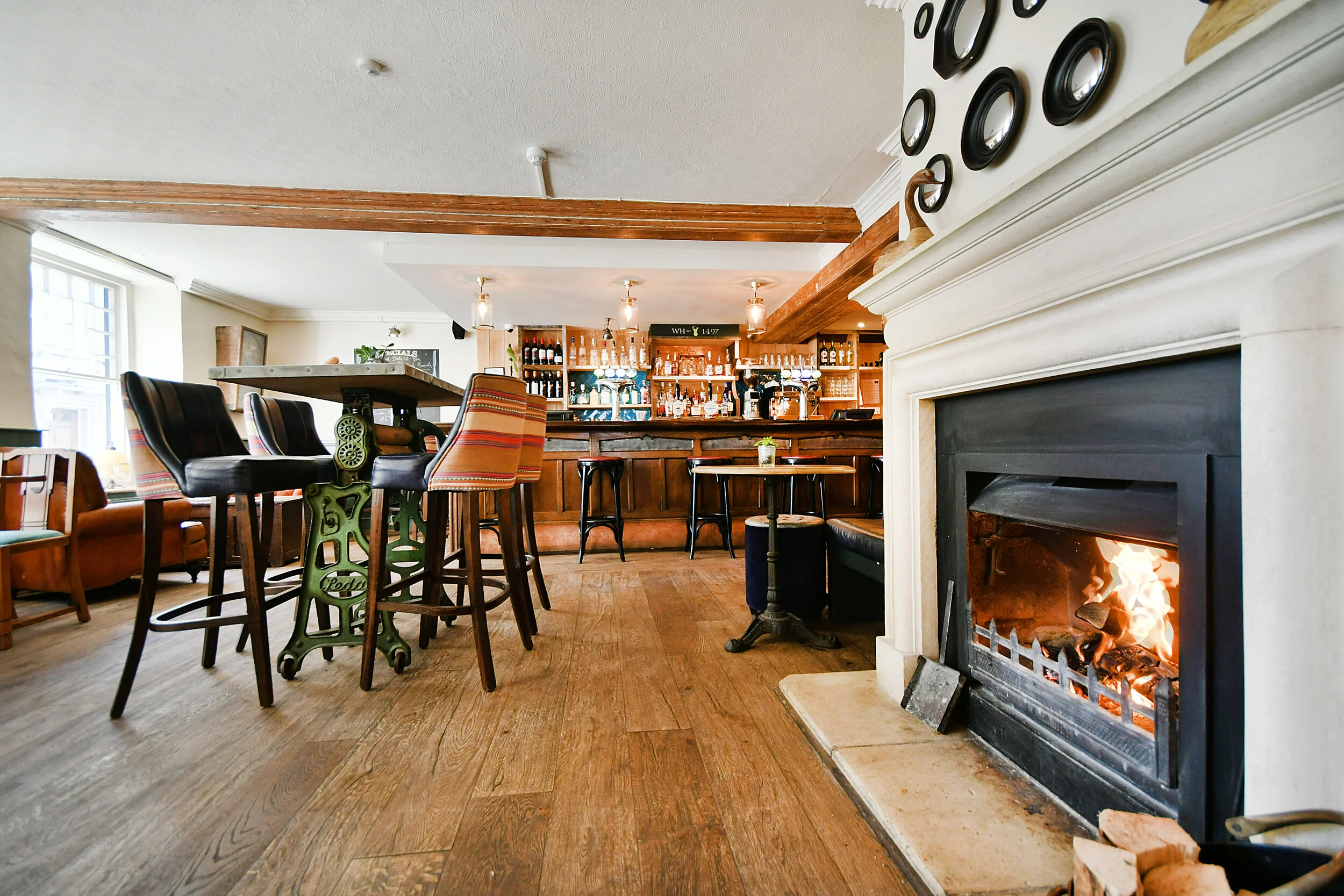 The welcoming bar and lit fireplace at The White Hart