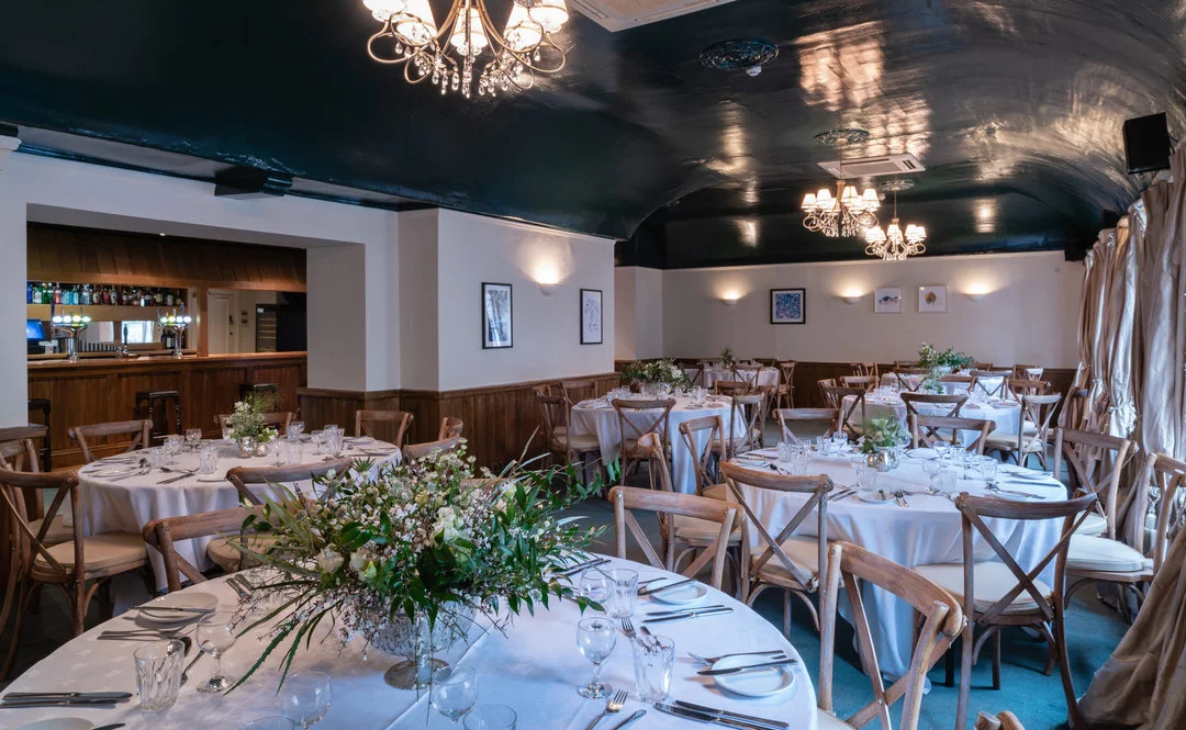 Wedding reception tables dressed for a celebration at The White Hart Wells